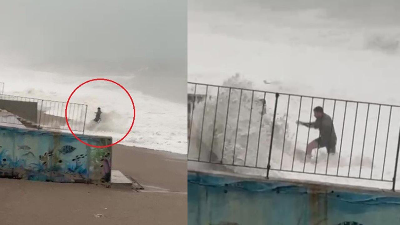 Son anda fark ettiği dev dalgaların arasında kalmaktan merdivene tutunarak kurtuldu